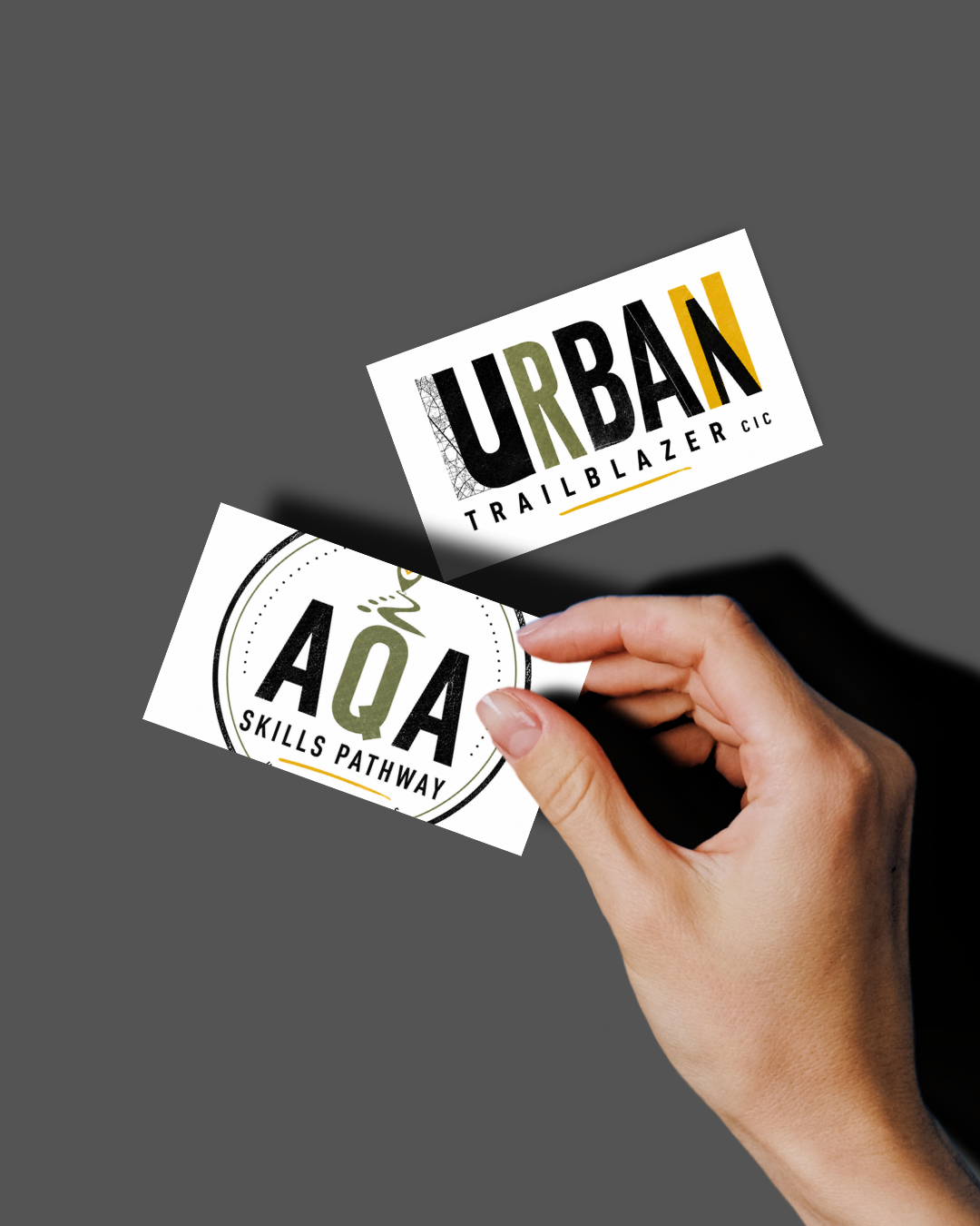 Business-card mockup showing Urban Trailblazer and AQA Skills Pathway designs