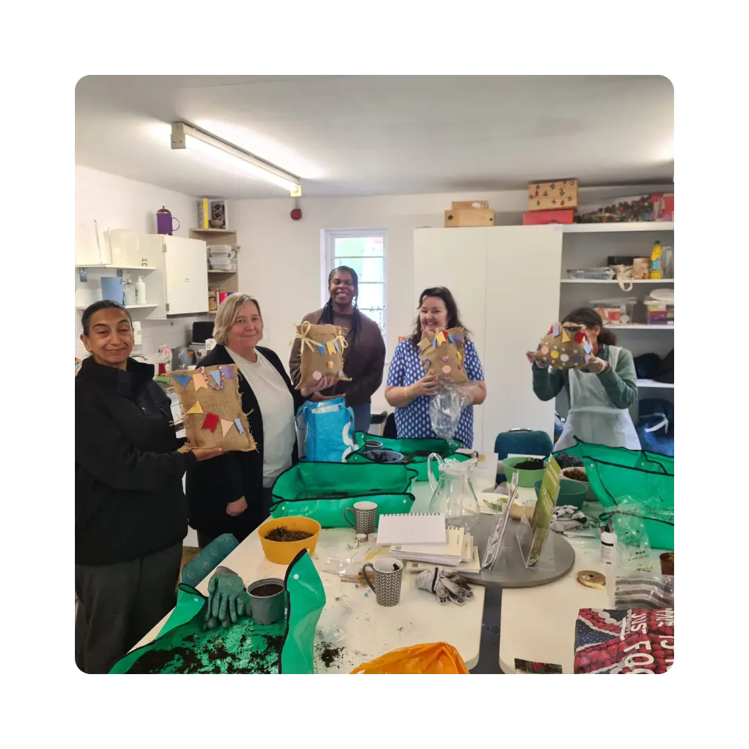 Staff engaging with workplace garden planters